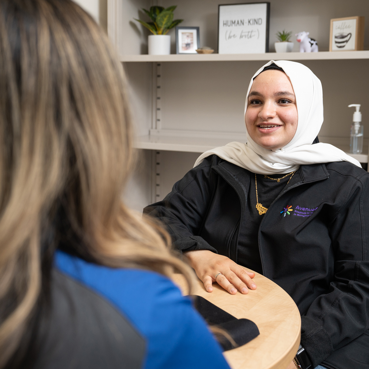 Image of female student in hijab speaking with an advisor